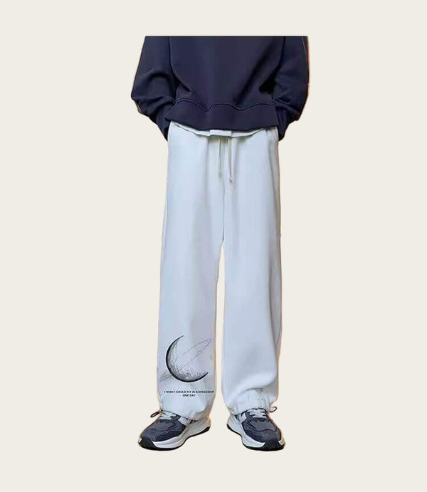 Person wearing a navy hoodie and white pants