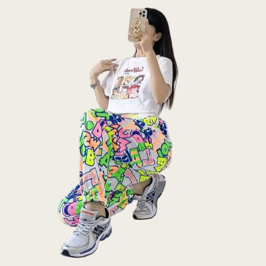 Person wearing a white t-shirt and colorful pants