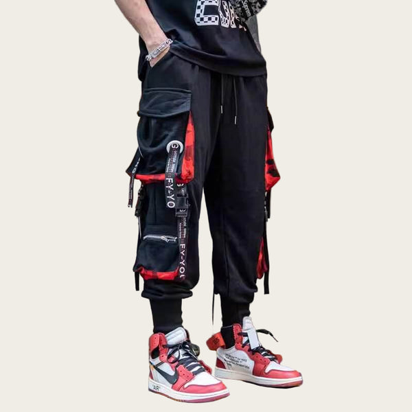 Person wearing black and red cargo pants with matching sneakers