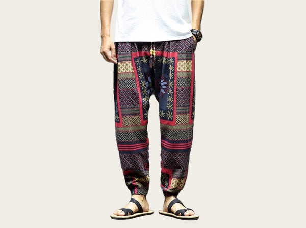 Person wearing patterned pants and sandals.