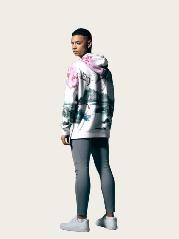 Person wearing a floral hoodie and gray pants on a dark background