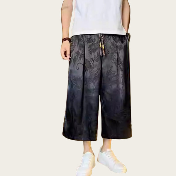 Person wearing black floral pants and white shoes