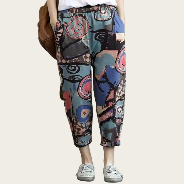 Colorful patterned pants worn by a person against a plain background