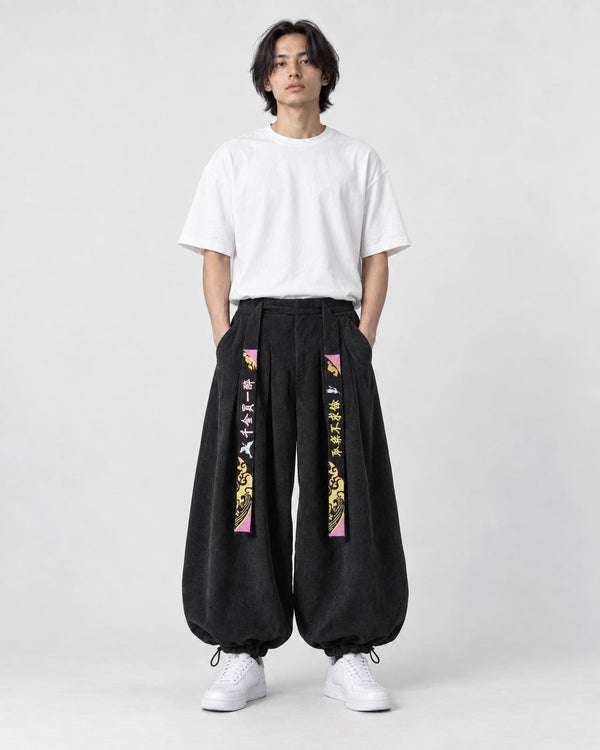 Model wearing the black crane embroidered corduroy pants, front view