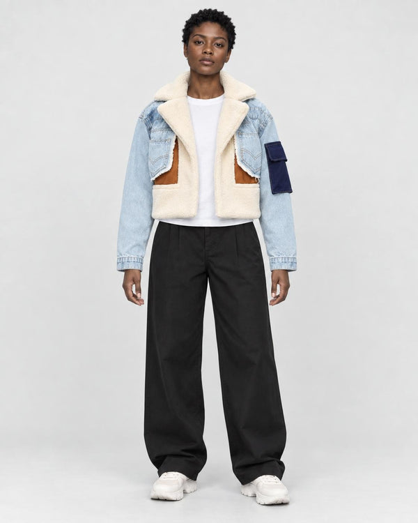 Model wearing the light blue cropped fleece panel jacket, front view