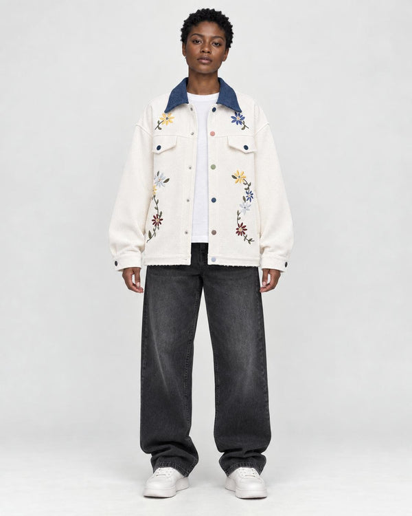 Model wearing the cream floral embroidered jacket with a denim-blue collar, front view