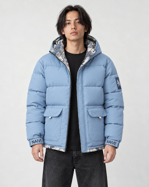 Model wearing the light blue puffer jacket with camouflage lining over a black tee, front view