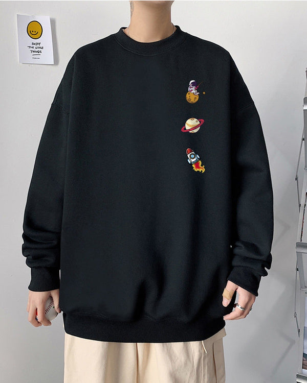 Black crewneck sweatshirt with an astronaut, a ringed planet and a rocket printed in a column on the left chest