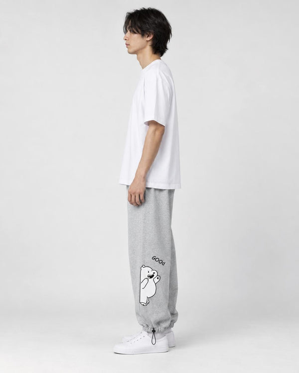 Model seen from the side in the heather gray bear jogger sweatpants with a white tee and white sneakers