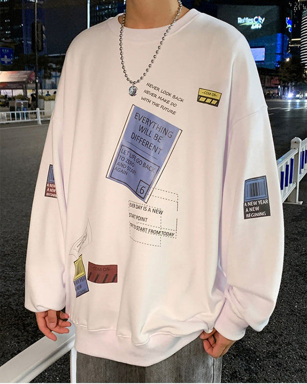 White crewneck sweatshirt with a tilted blue label, a yellow tag and a barcode patch on the sleeve, close view