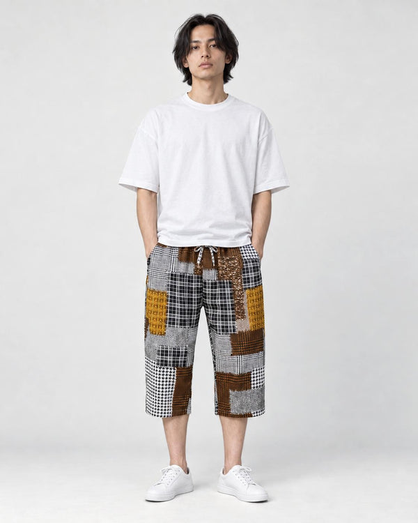 Model wearing the brown patchwork cropped pants with a white tee and white sneakers, front view