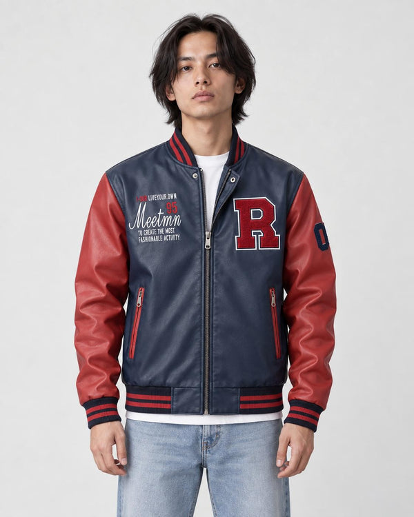 Man in a navy faux-leather varsity jacket with red sleeves and a red R patch, white tee and jeans, torso to mid-thigh