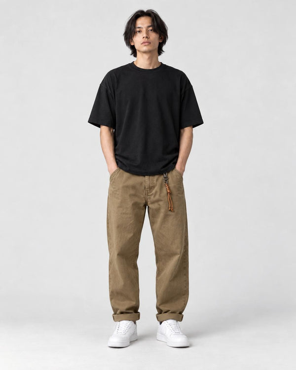 Model wearing the khaki cuffed chinos with a black tee and off-white sneakers, front view