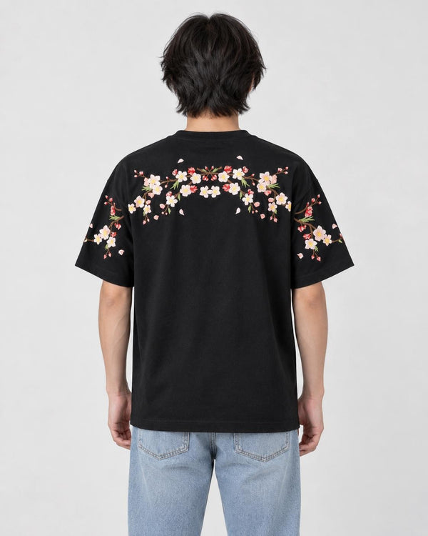 Model wearing the black plum blossom T-shirt, back view of the embroidered garland