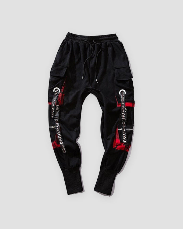 Black cargo joggers with red camo pocket linings and printed ribbon straps, flat view