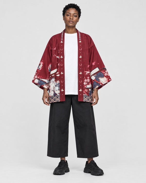 Model wearing the sakura print kimono jacket open, red side out, front view