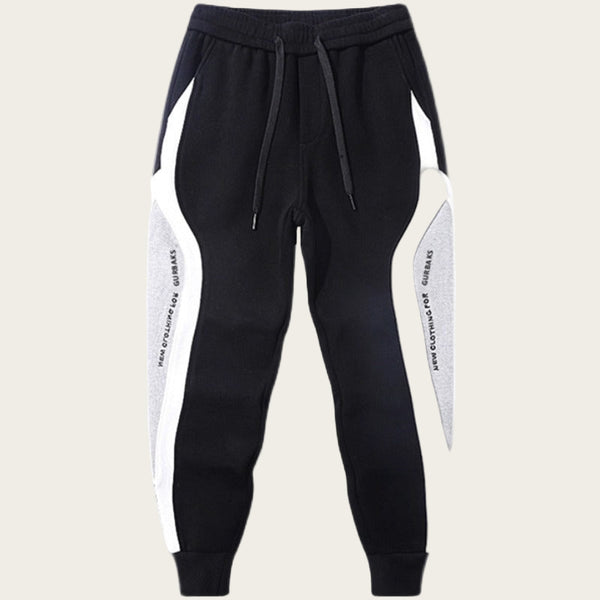 Black and white jogger pants with side stripes on a white background