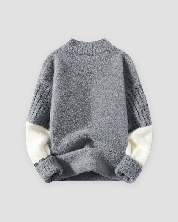 Gray fuzzy sweater with a small stag on the chest and cream lower sleeves