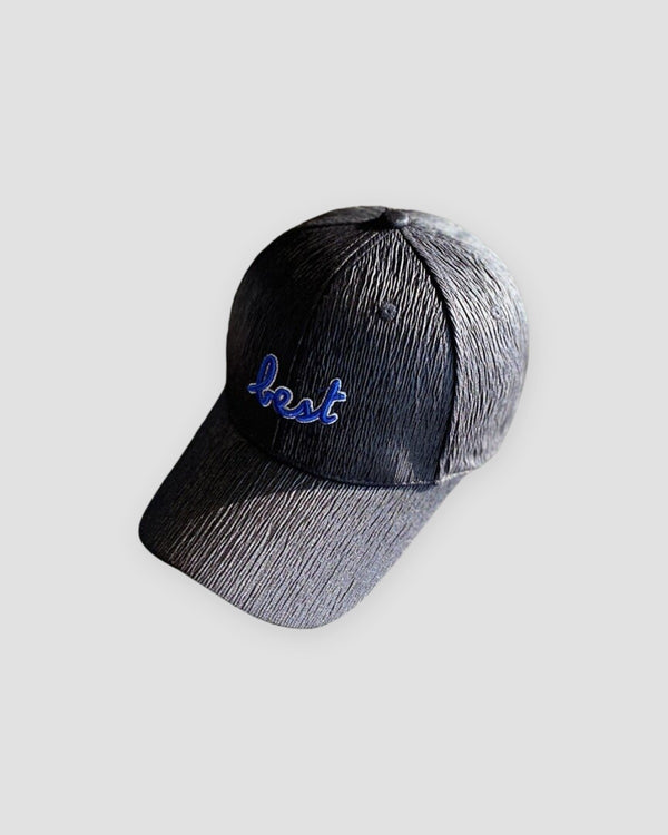 Black textured baseball cap with royal-blue cursive best embroidery on the front and a curved brim