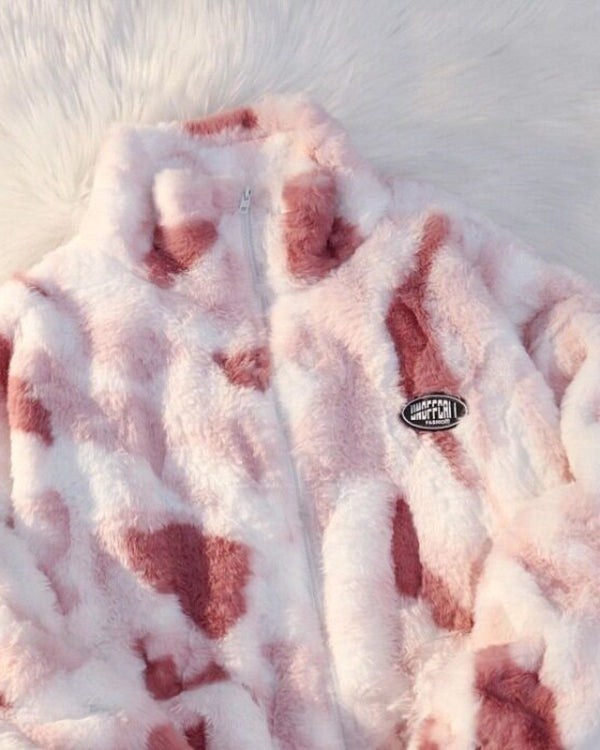 Close-up of the pink and white tie-dye plush jacket with its stand collar, zip and oval chest patch
