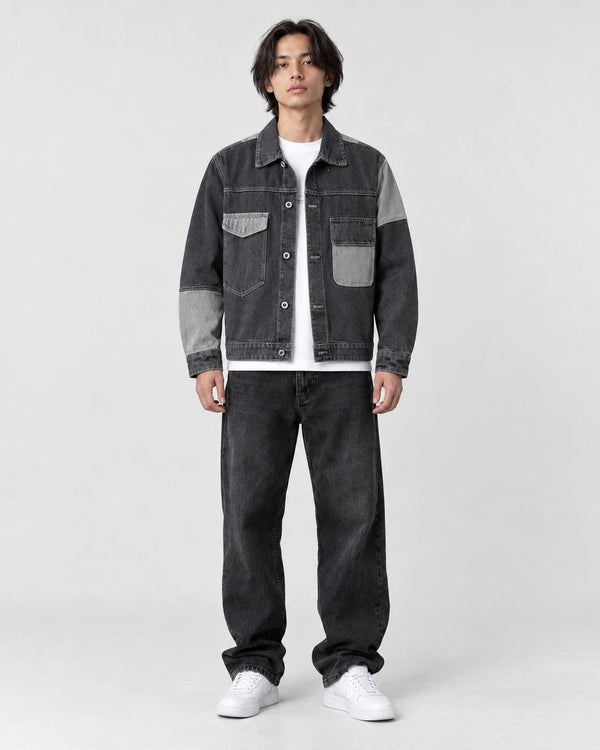 Model wearing the dark gray patchwork denim jacket over a white tee, front view
