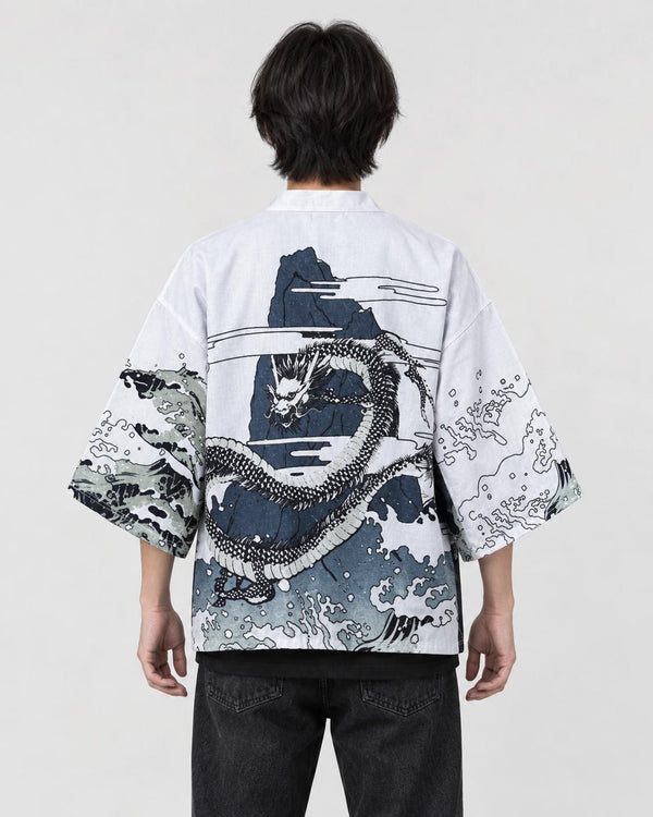 Man seen from behind in the white haori with a coiling gray dragon and black and white waves on the back, over a black tee