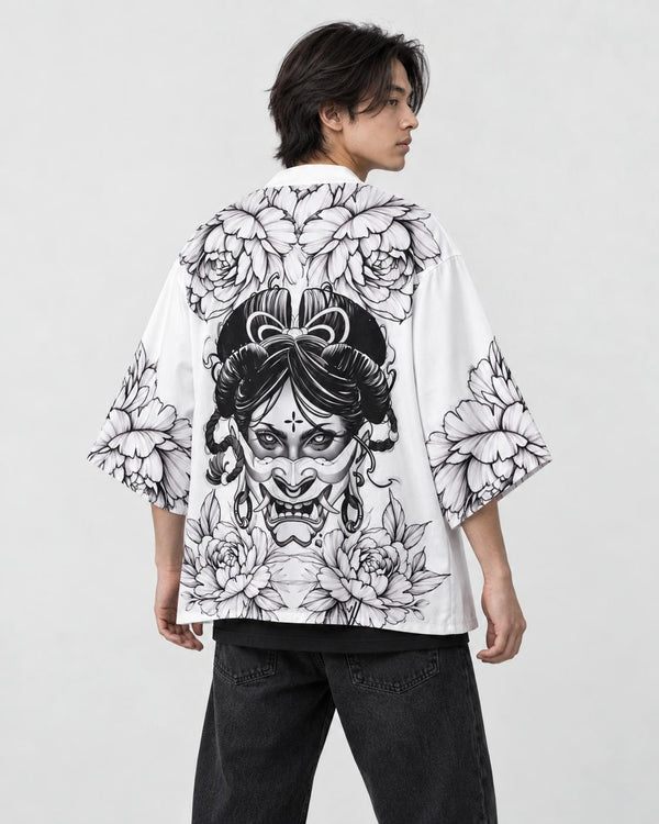 Man in the white haori seen from behind at an angle, with a black line-art demon mask and peonies on the back, black tee
