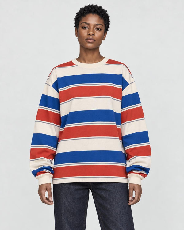 Model wearing the red striped crewneck sweatshirt with dark jeans, front view