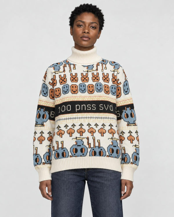 Model wearing the cream jacquard knit sweater with bunny and smiley face rows and a black lettering band, with dark jeans