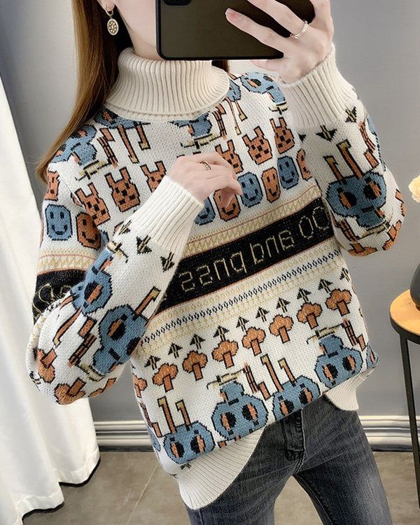 Cream jacquard knit sweater with rows of bunny and smiley faces, a black lettering band and blue figures near the hem