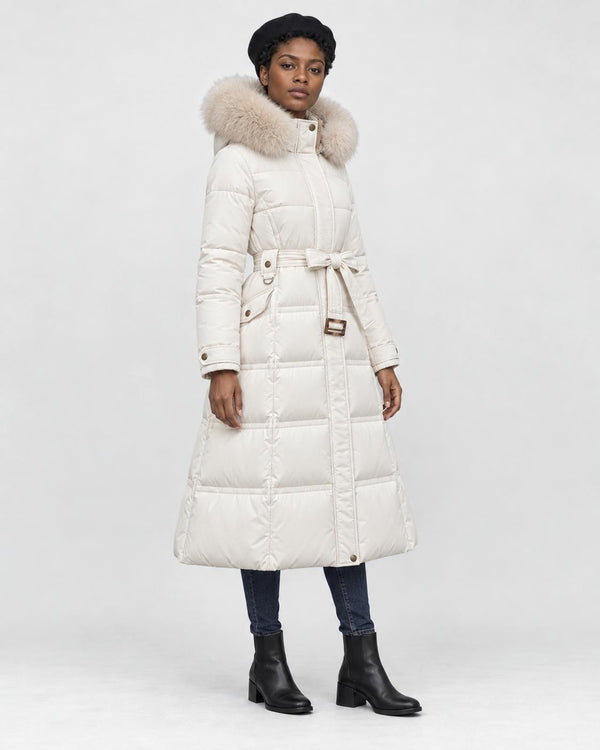 Model wearing the white long puffer coat with a khaki fluffy hood trim and a tie belt, three-quarter view