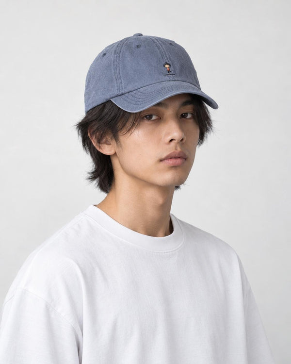 Model wearing the blue gray yoga embroidered baseball cap with a white tee, three-quarter view