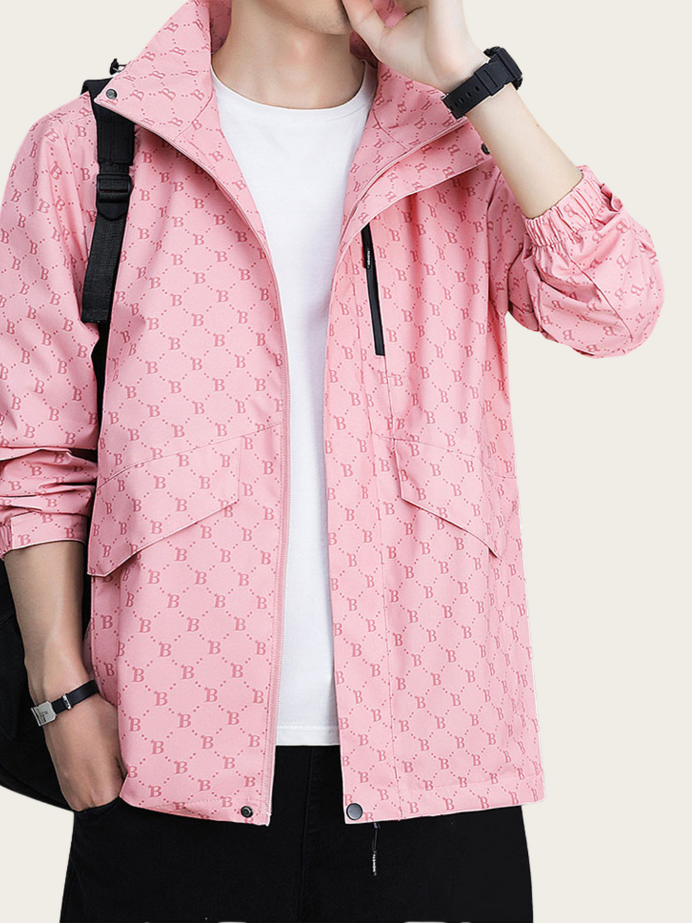 Person wearing a pink jacket with a pattern, white shirt, and black pants on a light gray background