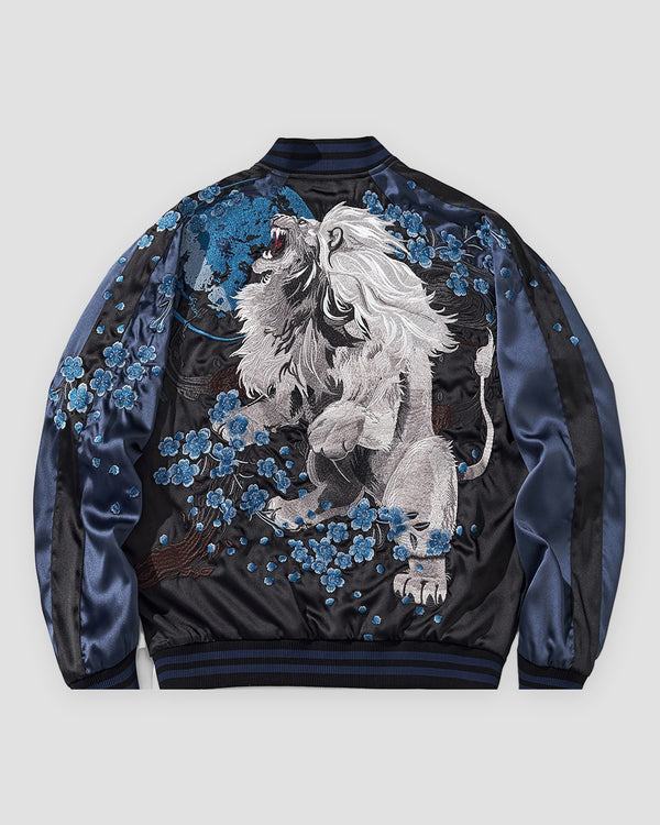 Black and navy souvenir jacket, back view, white lion embroidered among blue blossoms