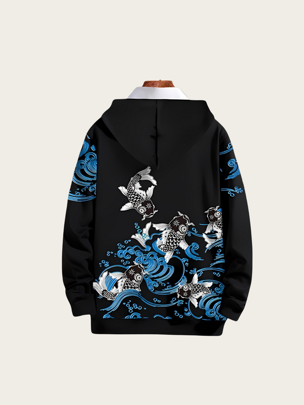 Black hoodie with blue and white fish design on a beige background