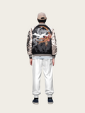 Person wearing a black and white varsity jacket with dragon design on a plain background