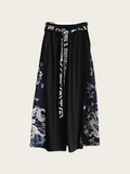 Black skirt with white floral patterns on a light gray background