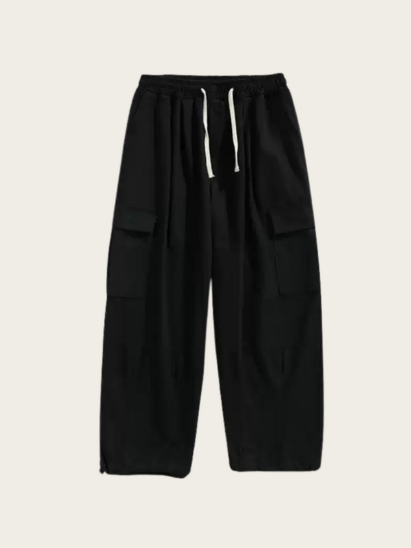 Black cargo pants with multiple pockets on a light beige background