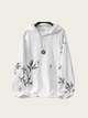 White hoodie with black floral patterns on sleeves against a white background