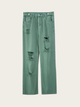 Green distressed jeans on a white background
