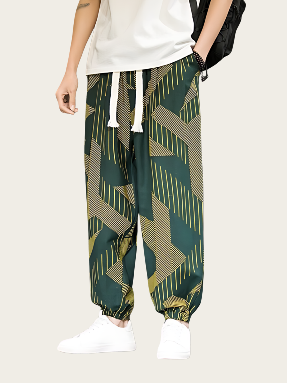 Person wearing green geometric patterned pants on a plain background