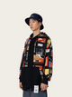 Person wearing a black jacket with colorful graphic designs and a black hat on a white background