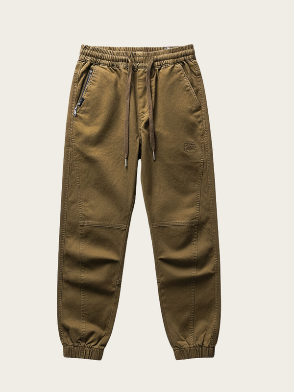 Brown jogger pants on a light beige background