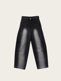 Black leather pants on a light beige background