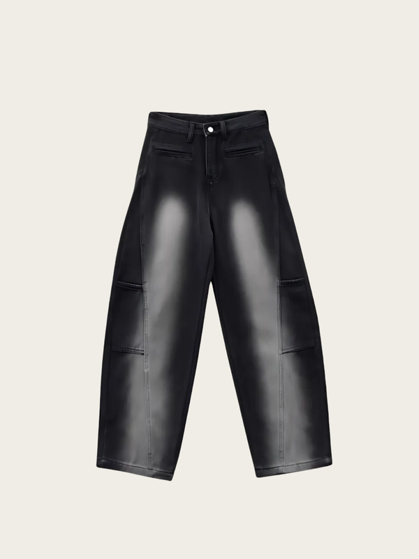 Black leather pants on a light beige background