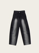 Black leather pants on a light beige background