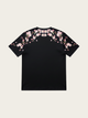 Black t-shirt with pink floral designs on a beige background