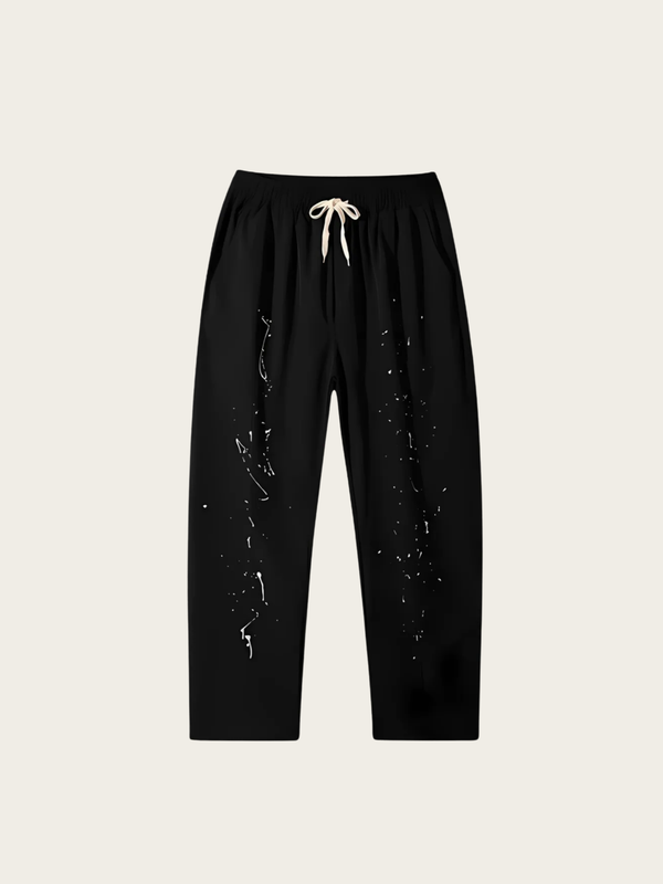 Black pants with white drawstring on a beige background