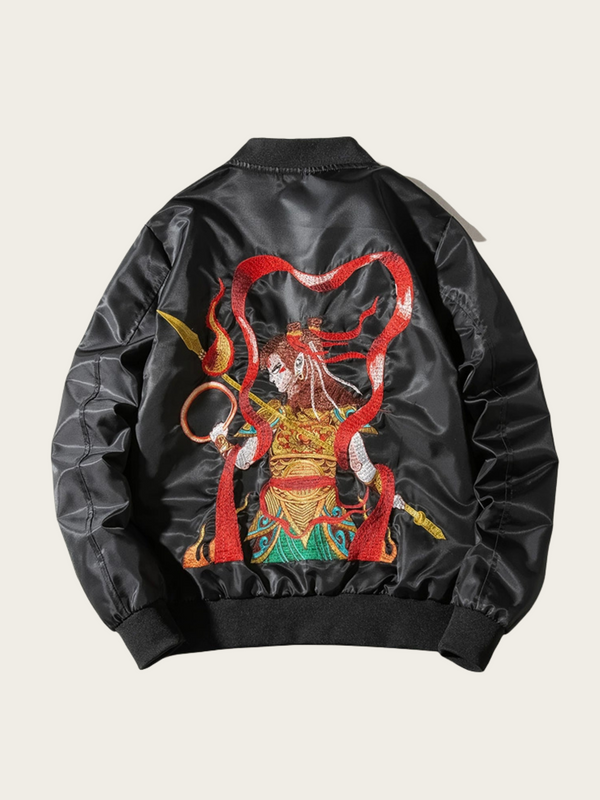 Black bomber jacket with colorful dragon design on the back against a light beige background