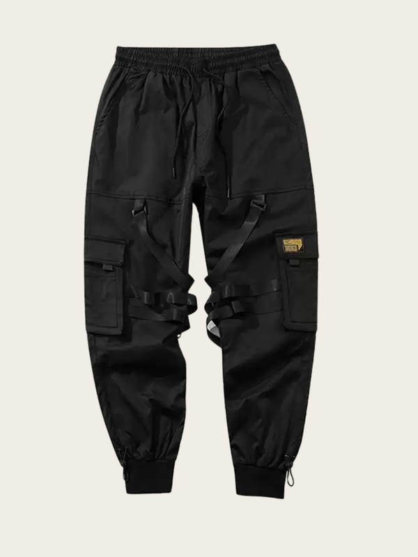 Black cargo pants with multiple pockets on a beige background